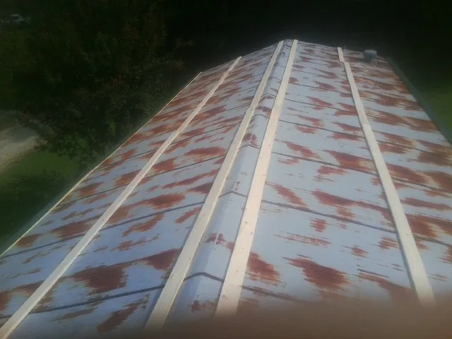 Rusted metal roof panels with new wood purlins before replacement — Storm Damage Roof Repair in Buckingham by Roofing Brothers